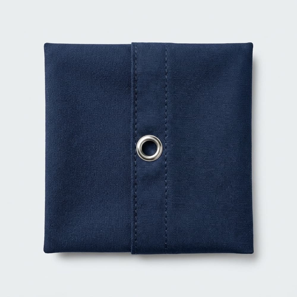 Taut navy marine canvas with a sewn seam and a metal grommet
